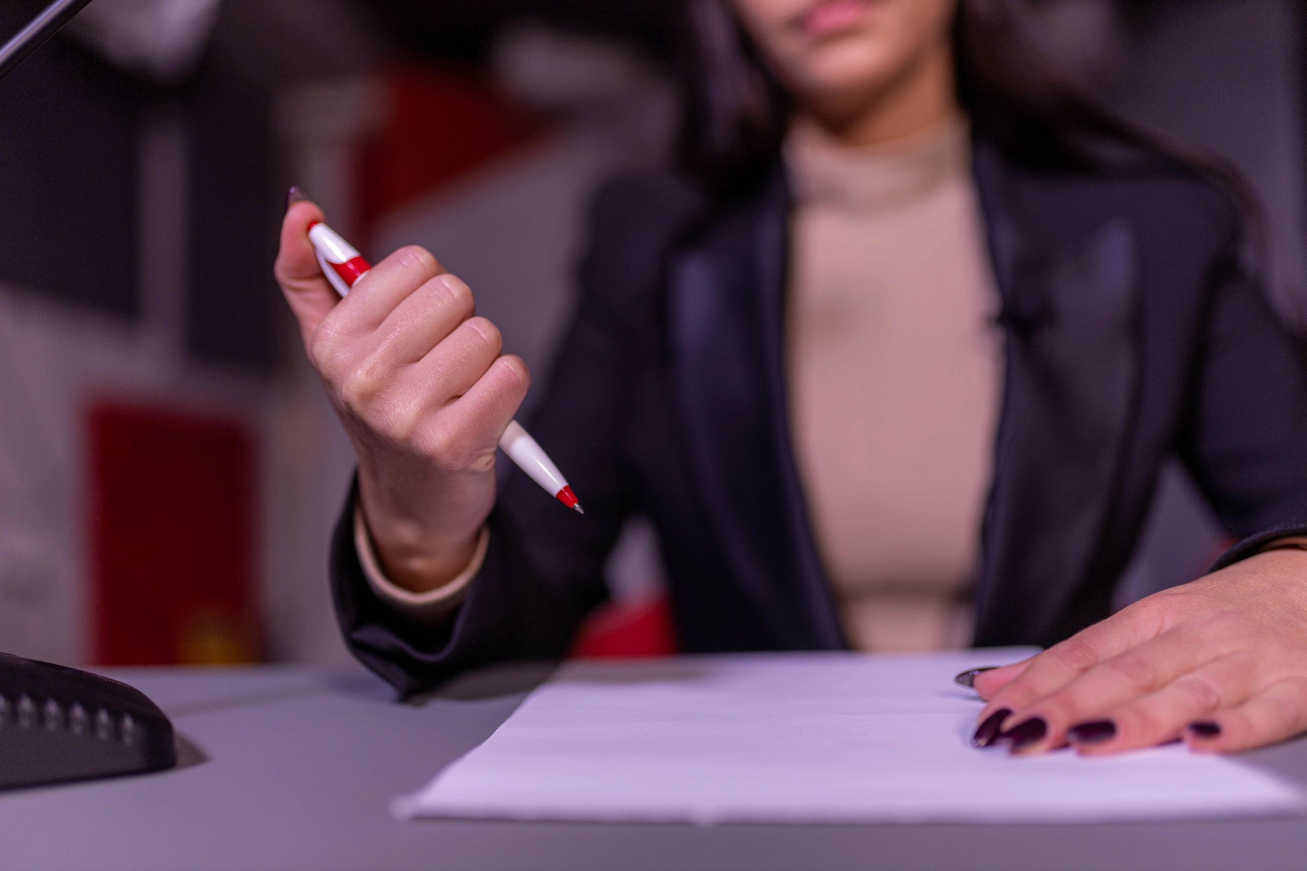 Newsroom professional preparing notes at a desk
